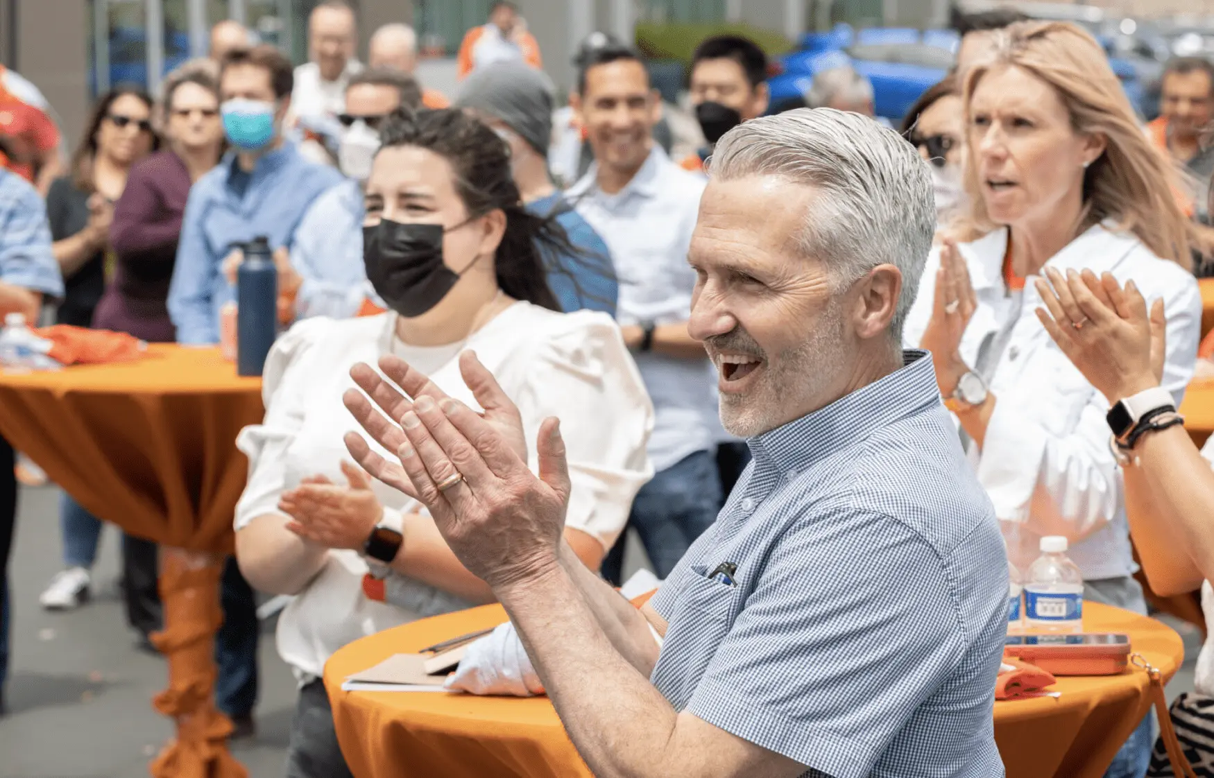 Imperative Care team members clapping at event